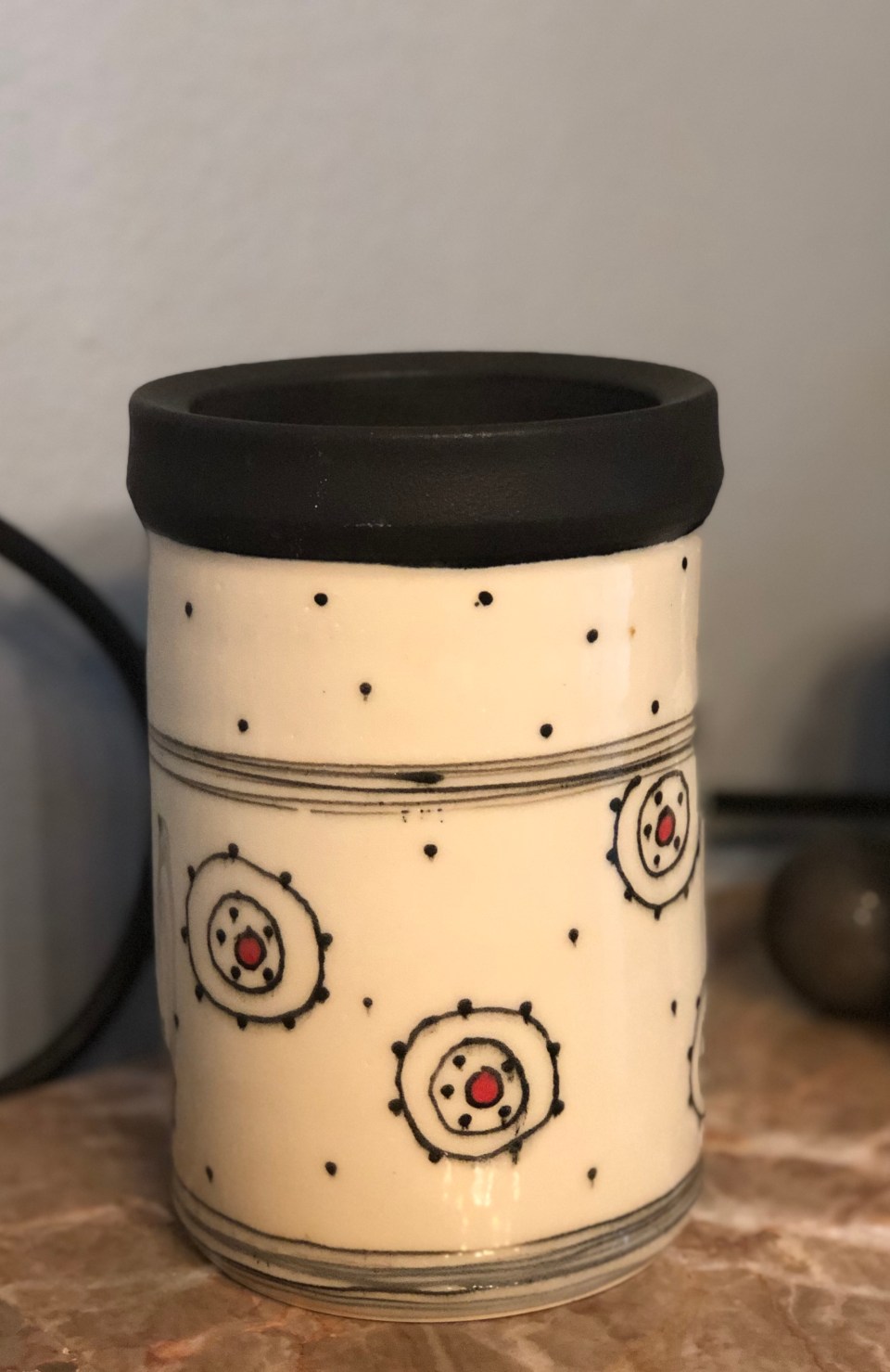 Pottery wine cooler with red dot and organic circles in black