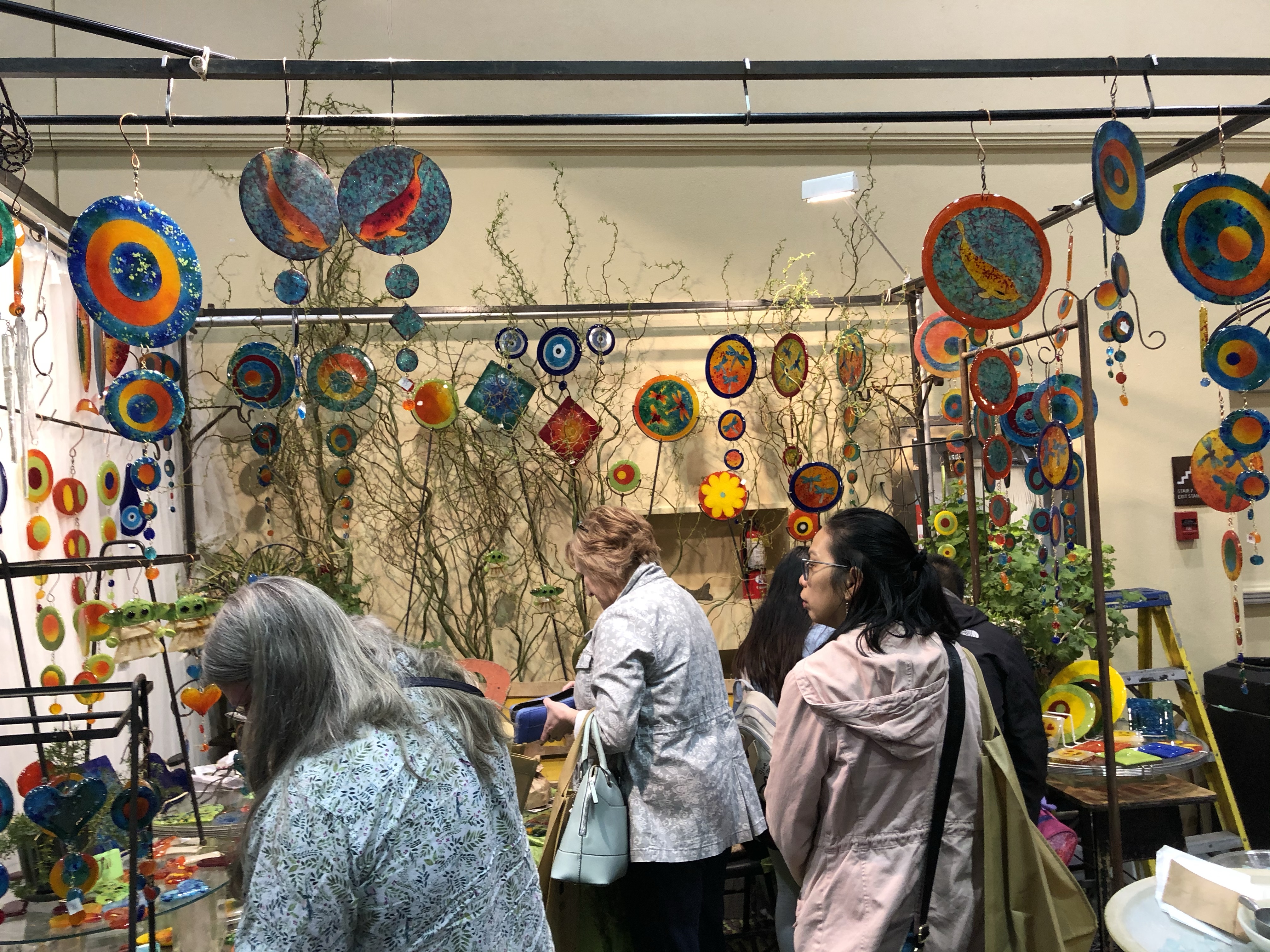 People shopping in an art booth